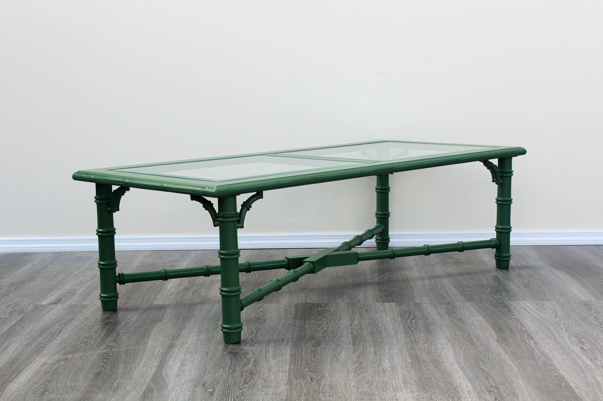 1970's Faux bamboo green coffee table with glass top.  This table is newly refinished in green with satin topcoat.  Dimensions: 54" Length x 24"Depth x 16"Height. 