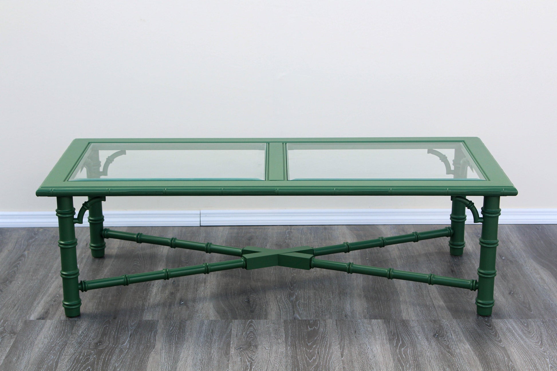 1970's Faux bamboo green coffee table with glass top.  This table is newly refinished in green with satin topcoat.  Dimensions: 54" Length x 24"Depth x 16"Height. 