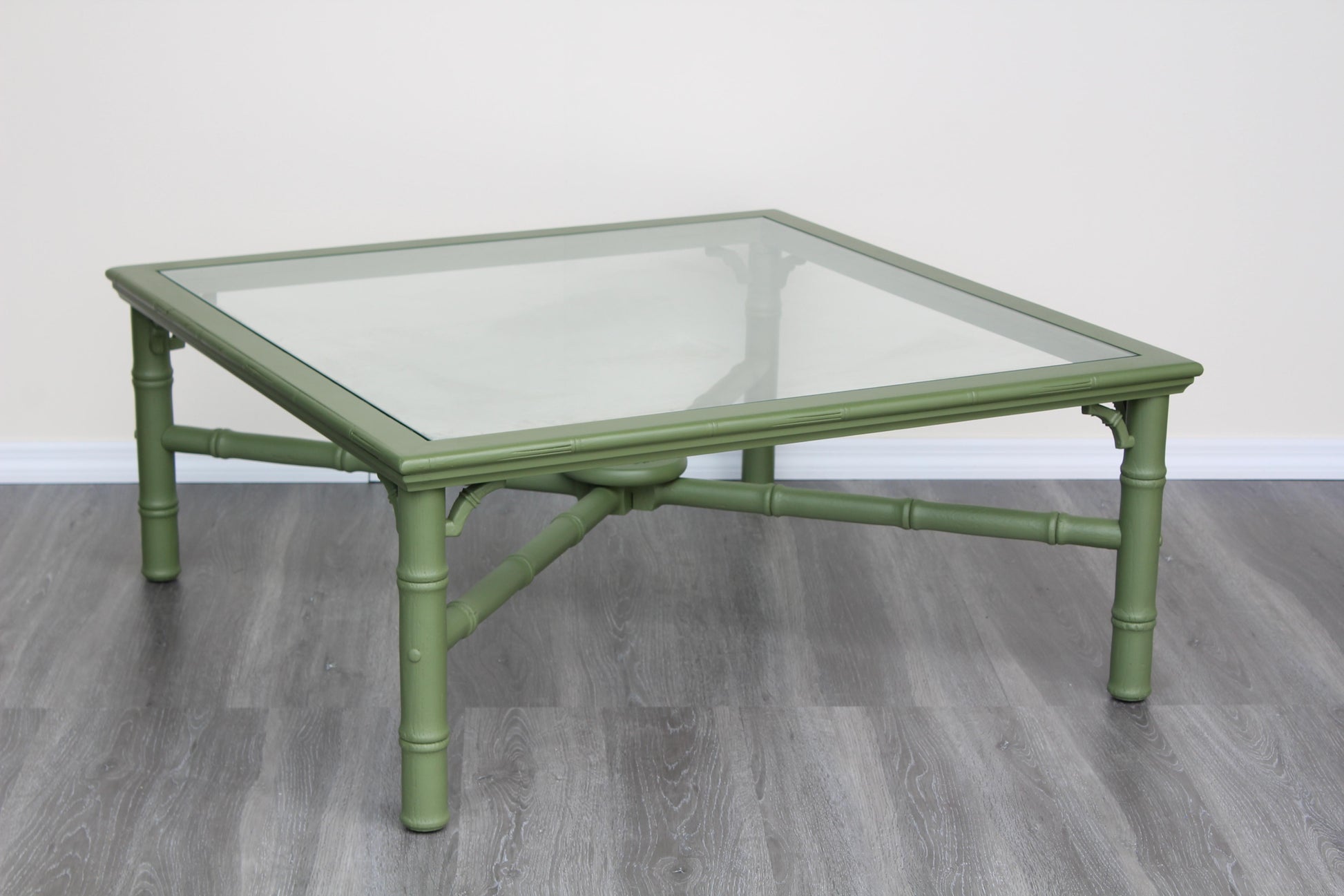 1970's faux bamboo walnut coffee table with glass top.  This table is professionally refinished in green with satin top coat.  Dimensions: 37"Width x 37"Depth x 16"Height. 