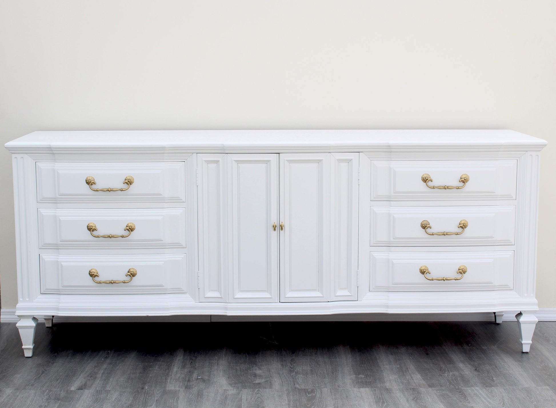 Mid-Century solid built walnut dresser of nine drawers.  This dresser is refinished in white with gloss topcoat.  Dimensions: 80"Width x 20"Depth x 33"Height. 