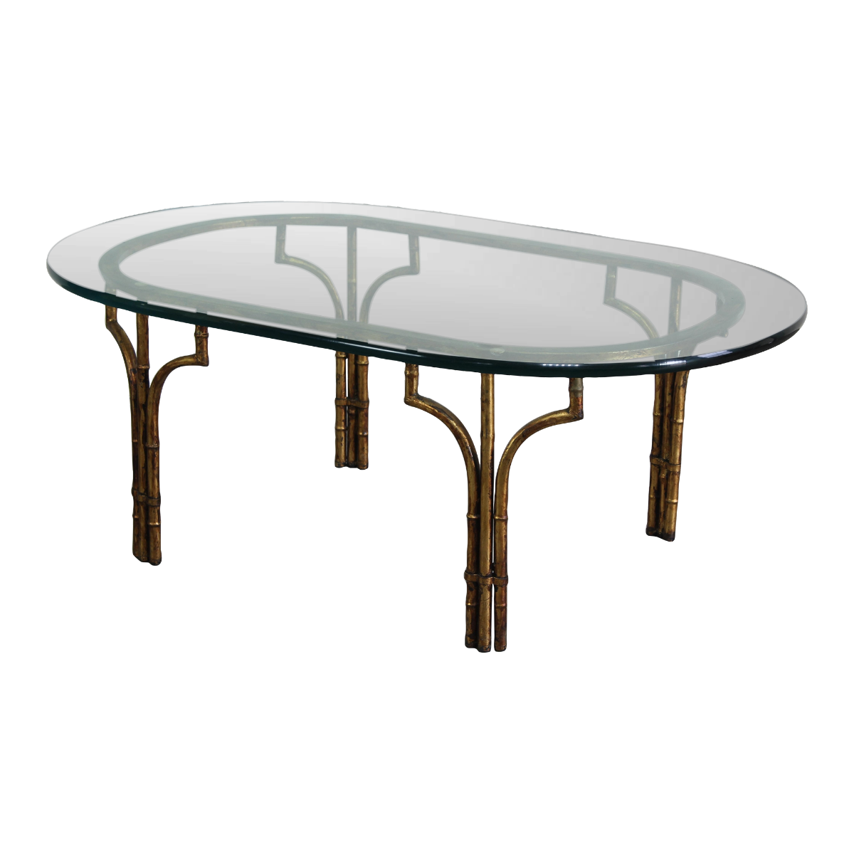 Vintage Hollywood Regency faux bamboo metal coffee table with glass top.  This is a gilt metal oval coffee table with glass top.  Dimensions; 46" Width x 26" Depth x 17" Height