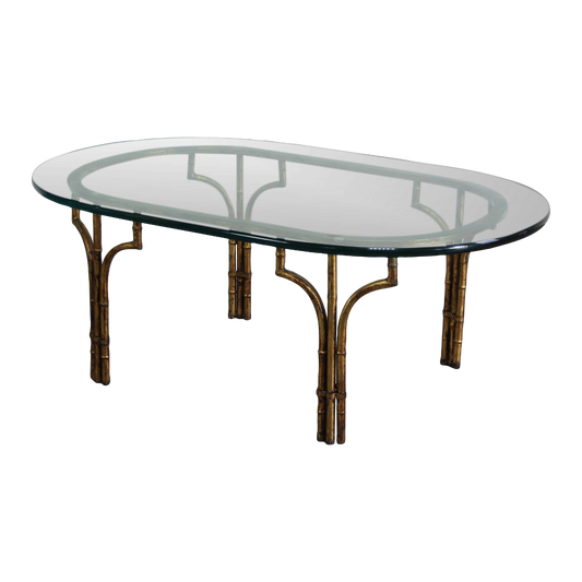 Vintage Hollywood Regency faux bamboo metal coffee table with glass top.  This is a gilt metal oval coffee table with glass top.  Dimensions; 46" Width x 26" Depth x 17" Height