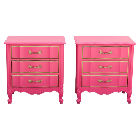 Pair of French Provincial Coral Pink Nightstands.  The nightstands are solid built with dovetail joints and metal hardware, are professionally refinished in coral pink and gold with satin topcoat.  Dimensions: 25"Width x 16"Depth x 26"Height. 