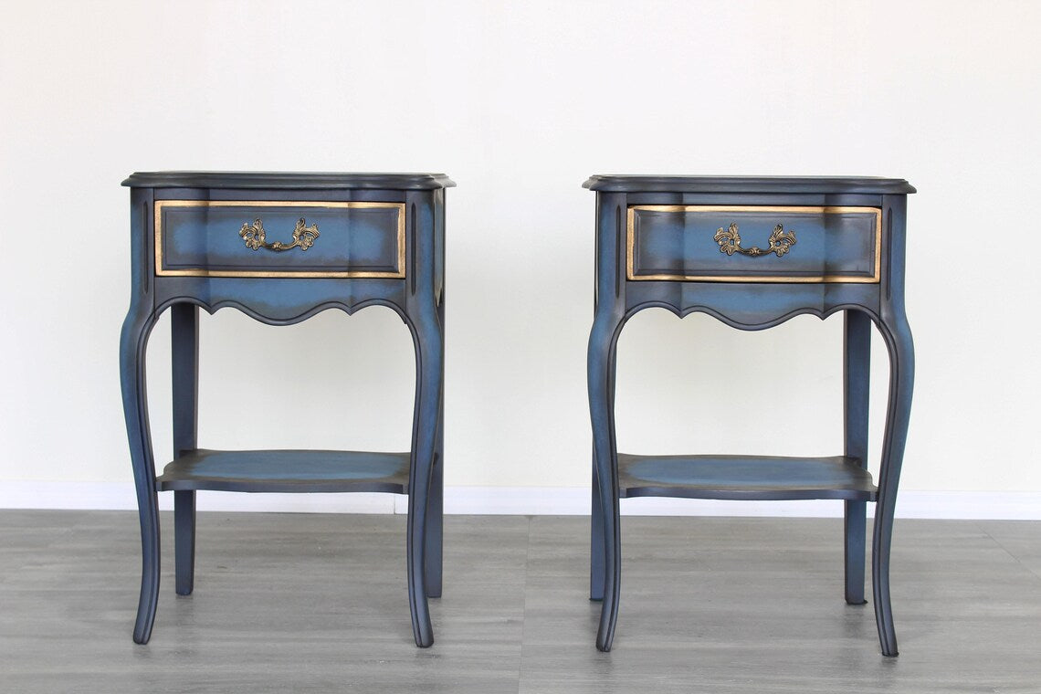 Vintage solid built French style nightstands with dovetail joints.  The nightstands are professionally refinished in blue with an antique glaze and gold painted accents.  Dimensions; 19" Width x 15" Depth x 29"Height. 