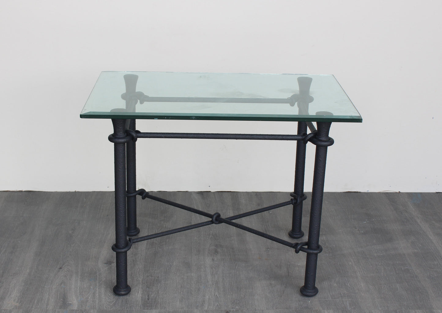 Vintage Giacometti style Iron side table with glass top.  Dimensions:30"Width x 20"Depth x 22"Height. 