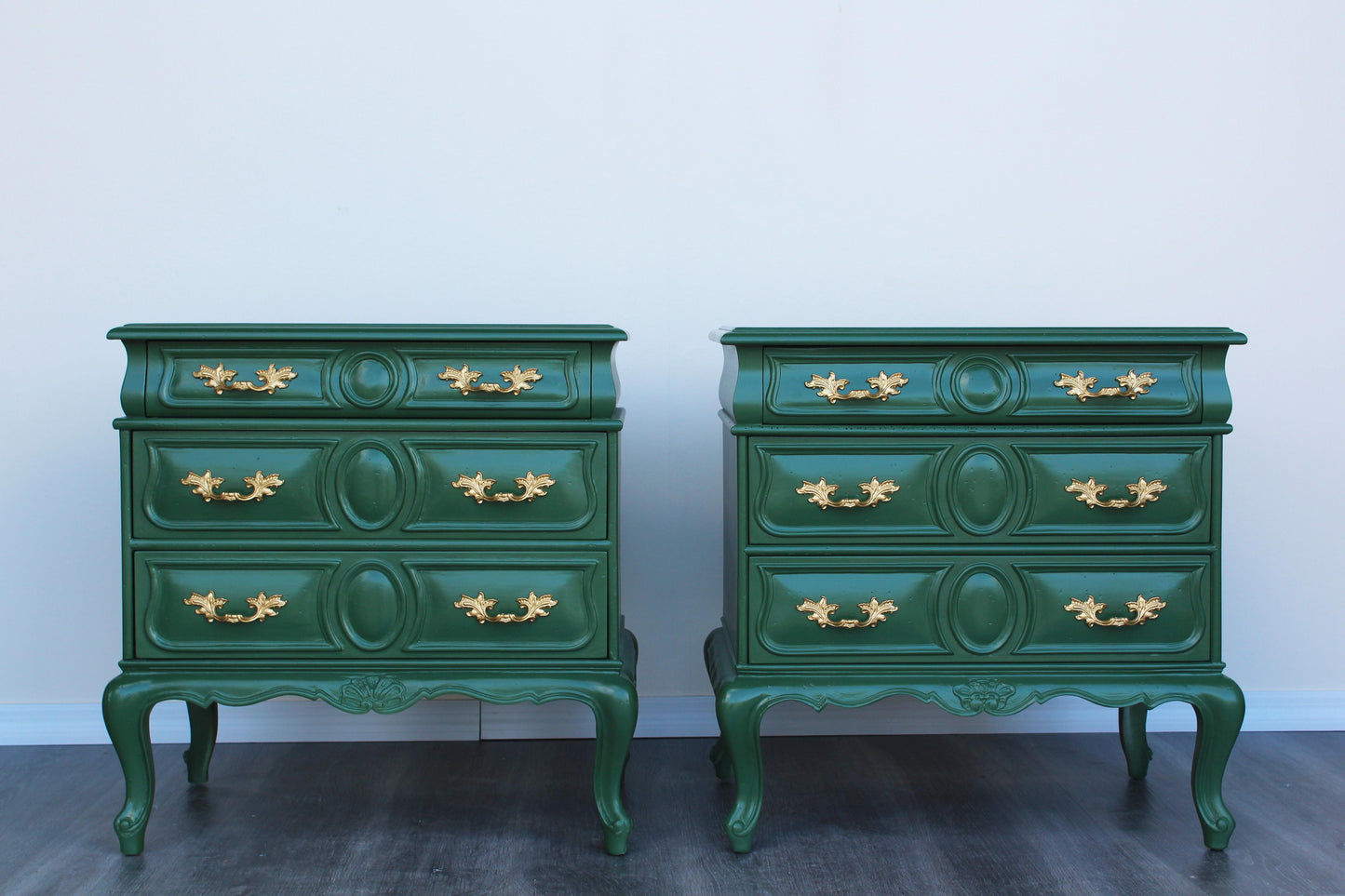 Pair of solid built provincial style nightstands.  The nightstands were professionally painted in green with gloss top coat and gold painted hardware.  Dimensions: 23"Width x 17"Depth x 23.5"Height. 