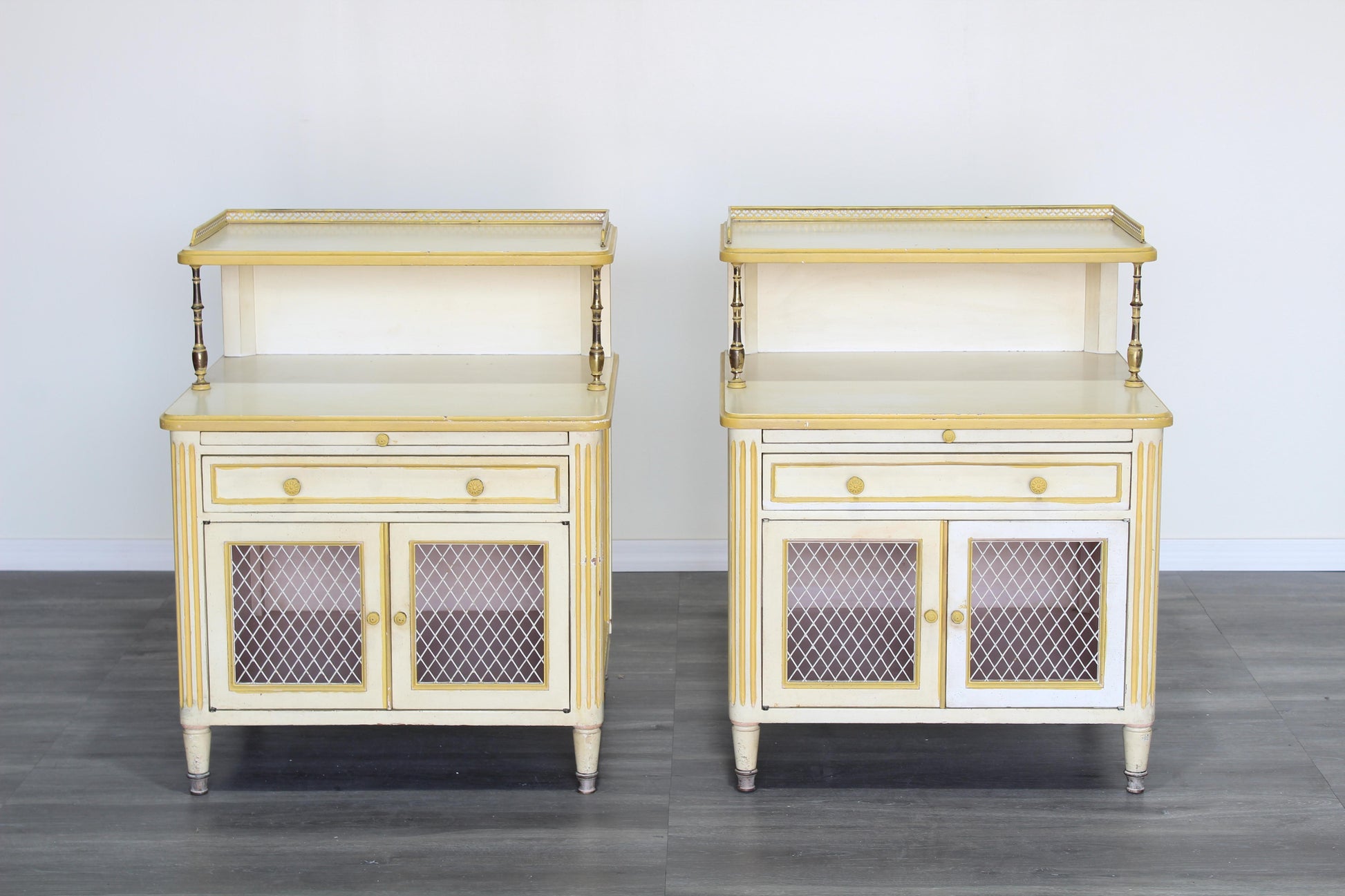 Pair of Late 20th century nightstands.  The nightstands are solid built with dovetail joints and brass accents, and a tray top, a pull out tray and a single drawer with storage space.  Dimensions; 24" Width x 21' Depth x 31" Height x 22" Height to middle top.