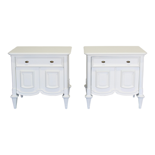 Pair of Mid century modern cream nightstands.  The nightstands are solid built with dovetail joints, are professionally refinished in a white cream color with a satin finish.  Dimensions; 27" Width x 19" Depth x 26" Height.