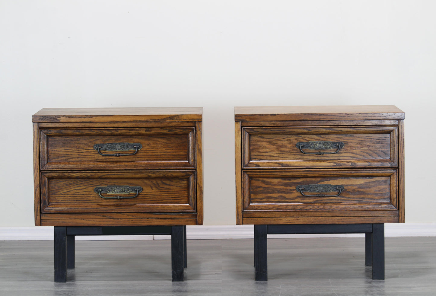 Pair of Mid century walnut nightstands.  The nightstands are solid built with dovetail joints and metal hardware.  Dimensions: 24"Width x 16"Depth x 24"Height. 