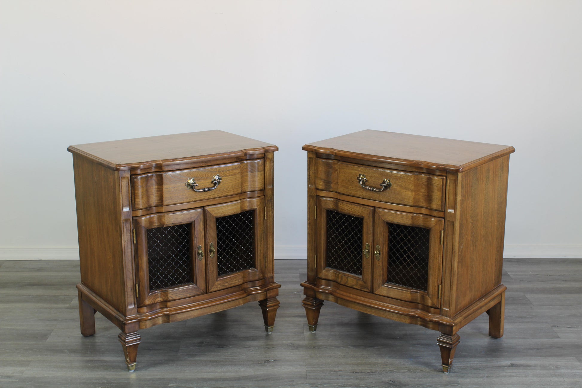 Pair of mid century walnut nightstands of single drawer and double doors with a lot of storage space.  Dimensions; 24" Width x 17" Depth x 27" Height. 