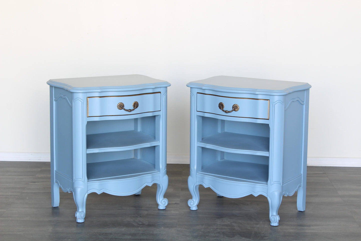 Vintage solid built pair of nightstands.  The nightstands are professionally refinished in a lovely pastel blue with a satin finish.  Dimensions: 23"Width x 16"Depth x 27"Height. 