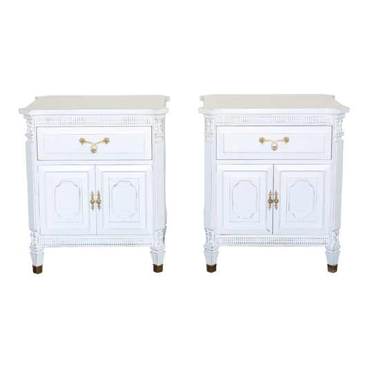 Pair of white neoclassical style nightstands.  The nightstand are solid built with dovetail joints, are professionally refinished in white with a distressed finish.  Dimensions: 25"Width x 20"Depth x 28"Height. 