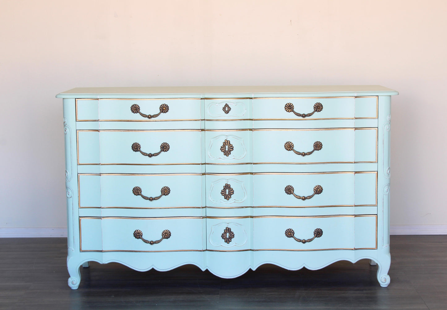 Vintage French provincial dresser of six drawers.  This is a solid built dresser with dovetail joints, professionally finished in mint green with gold painted accents and a distress finish.  Dimensions: 62"Width x 22"Depth x 36"Height. 