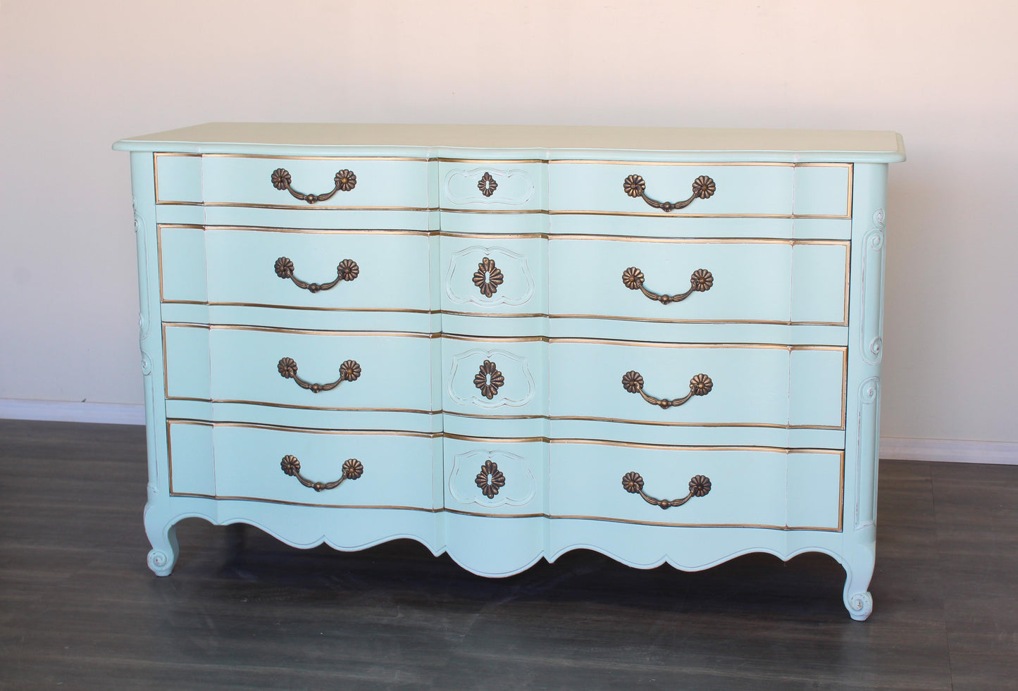 Vintage French provincial dresser of six drawers.  This is a solid built dresser with dovetail joints, professionally finished in mint green with gold painted accents and a distress finish.  Dimensions: 62"Width x 22"Depth x 36"Height. 