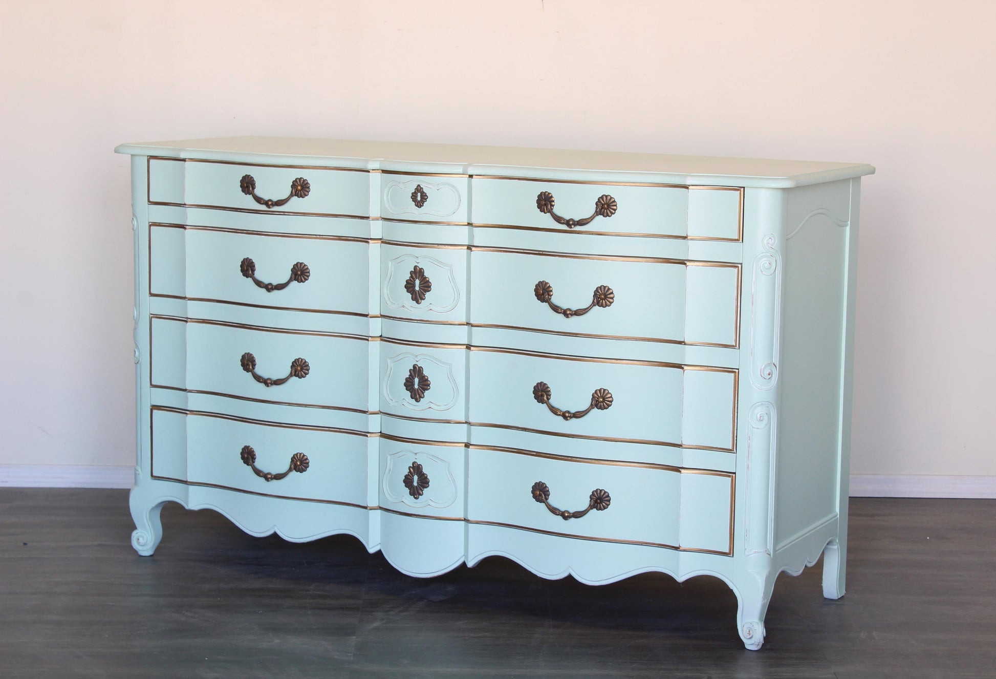 Vintage French provincial dresser of six drawers.  This is a solid built dresser with dovetail joints, professionally finished in mint green with gold painted accents and a distress finish.  Dimensions: 62"Width x 22"Depth x 36"Height. 