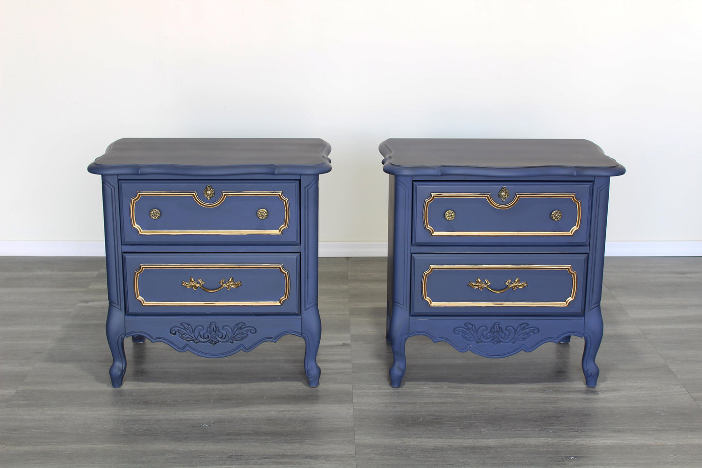 Vintage pair of French provincial Nightstands.  The nightstands are solid built with dovetail joints, and are professionally refinished in blue with an antique glaze and gold painted accents.  Dimensions; 25" Width x 16" Depth x 25" Height