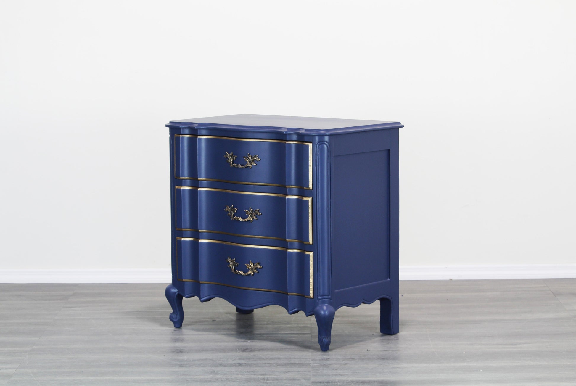 Vintage French style nightstand.  This nightstand is solid built with dovetail joints, is professionally refinished in blue with a satin finish and gold painted accents.  Dimensions; 29" Width x 17"Depth x 28" Height. 