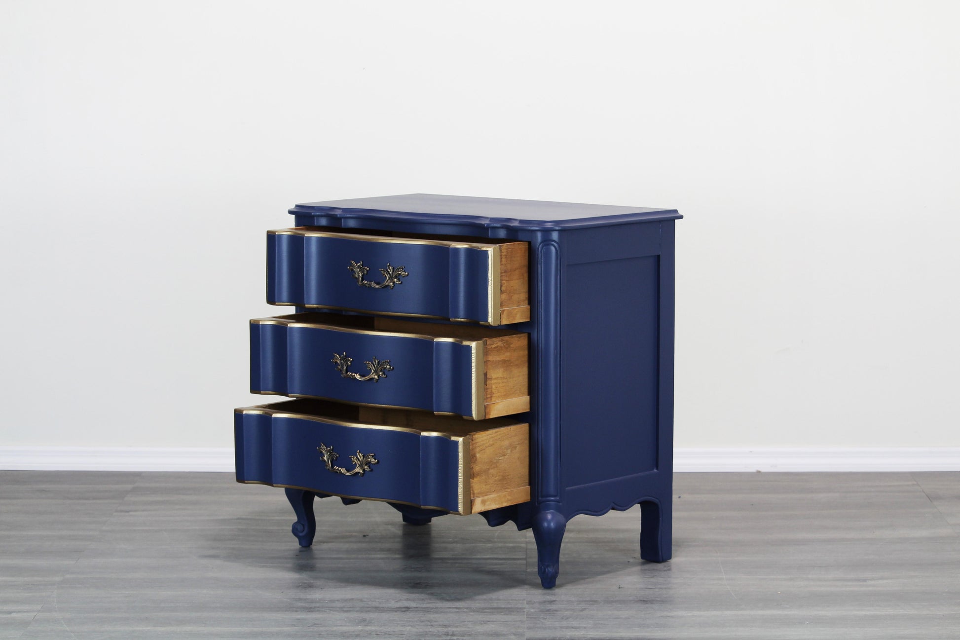 Vintage French style nightstand.  This nightstand is solid built with dovetail joints, is professionally refinished in blue with a satin finish and gold painted accents.  Dimensions; 29" Width x 17"Depth x 28" Height. 