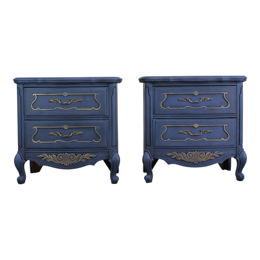 Vintage pair of French style nightstands of two drawers.  The nightstand are professionally refinished in blue with gold painted accents in an antique glaze.  Dimensions; 26" With x 15" Depth x 25" Height. 