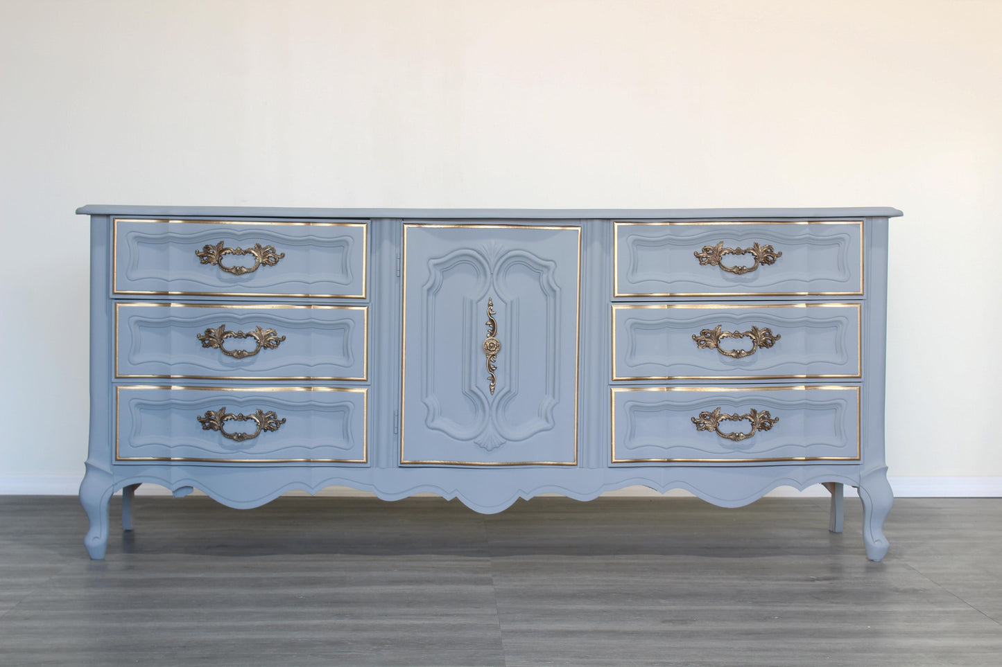 Vintage French provincial dresser of nine drawers.  This is a solid built dresser with dovetail joints, professionally refinished in gray with gold painted accents.  Dimensions; 72" Width x 19" Depth x 31" Height. 