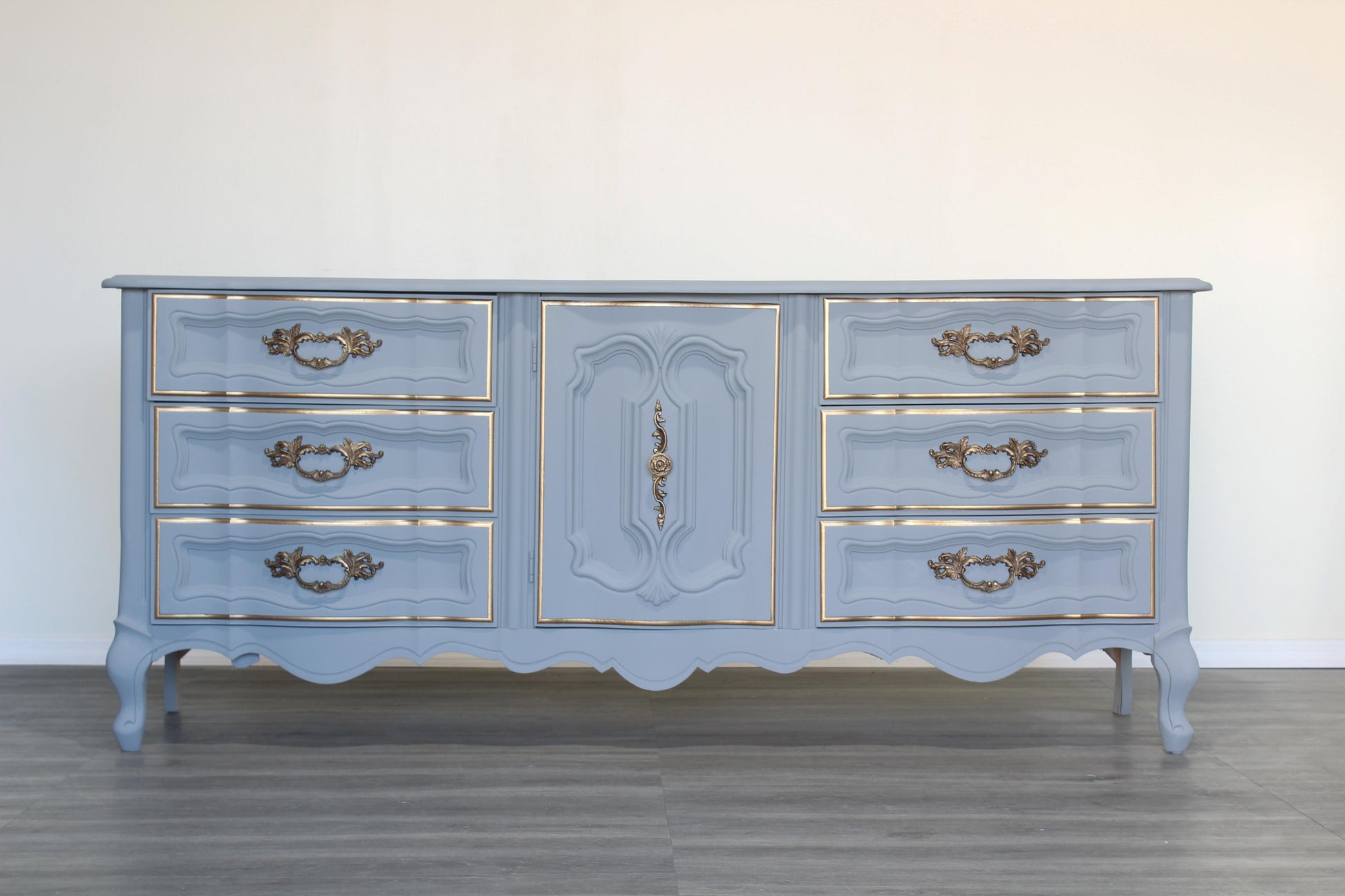 Vintage French provincial dresser of nine drawers.  This is a solid built dresser with dovetail joints, professionally refinished in gray with gold painted accents.  Dimensions; 72" Width x 19" Depth x 31" Height. 