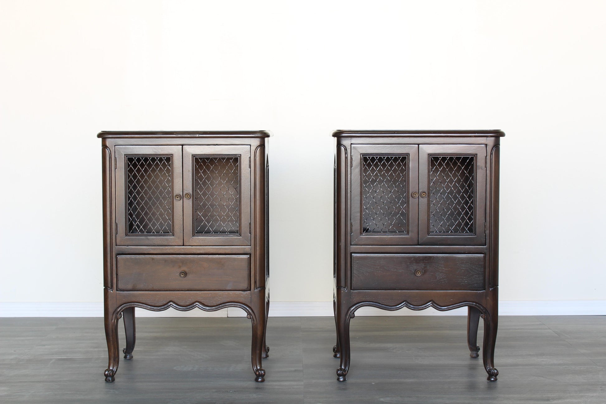 Vintage French style nightstands.  The nightstands are solid built with dovetail joints, refinished in a dark walnut.  Dimensions; 20" Width x 15"Depth x 29"Height. 