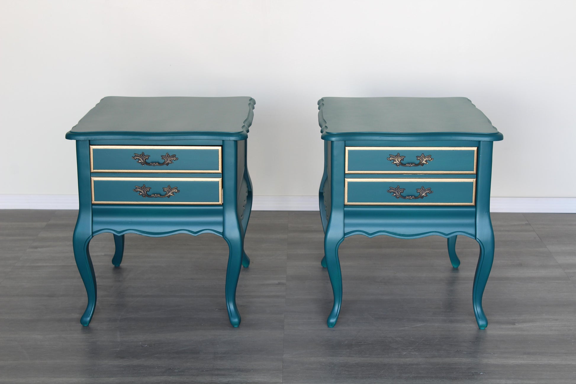 Vintage French style nightstands of single drawers.  The nightstands are professionally refinished in turquoise with gold painted accents in a satin finish.  Dimensions; 20"Width x 26" Depth x 23"Height. 