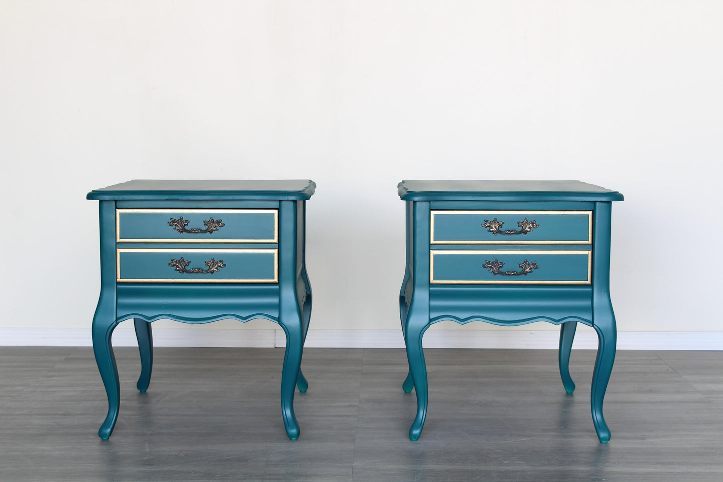 Vintage French style nightstands of single drawers.  The nightstands are professionally refinished in turquoise with gold painted accents in a satin finish.  Dimensions; 20"Width x 26" Depth x 23"Height. 