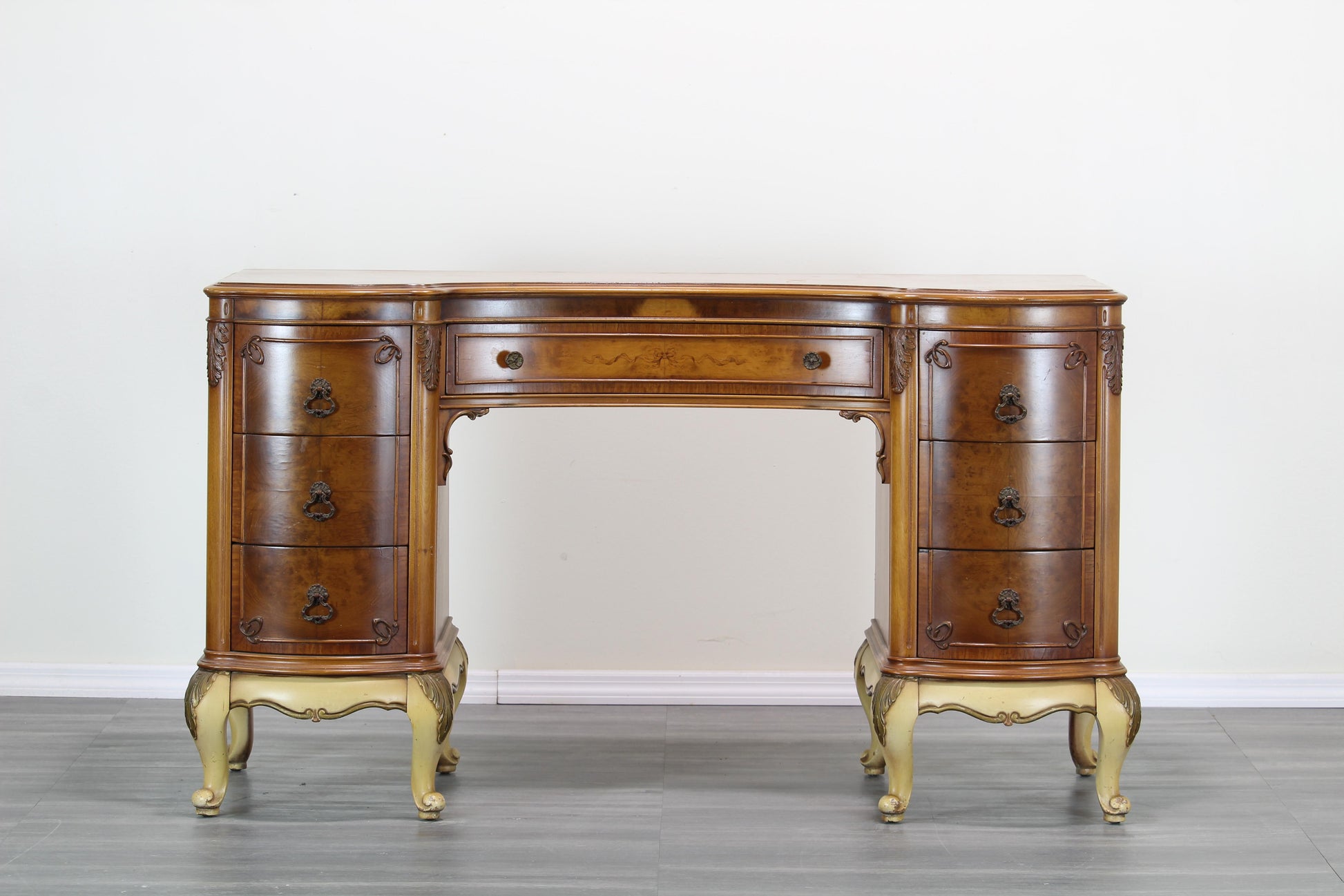 Vintage Hollywood Regency walnut burlwood writing desk.  This desk is solid built with dovetail joints and brass hardware.  Dimensions: 52"Width x 20"Depth x 30"Height. 