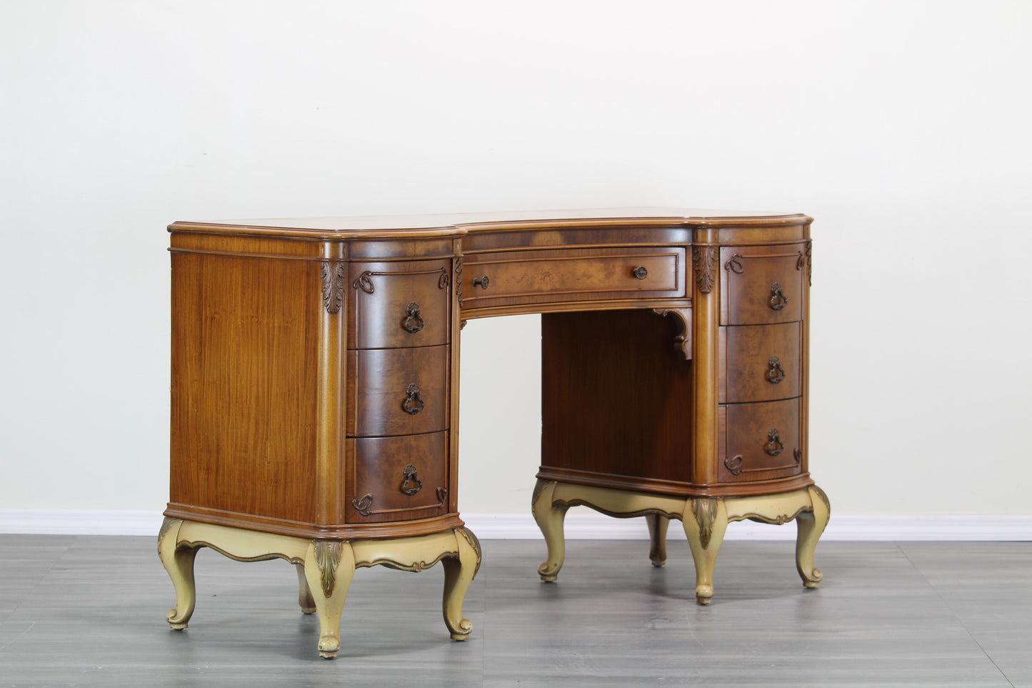 Vintage Hollywood Regency walnut burlwood writing desk.  This desk is solid built with dovetail joints and brass hardware.  Dimensions: 52"Width x 20"Depth x 30"Height. 