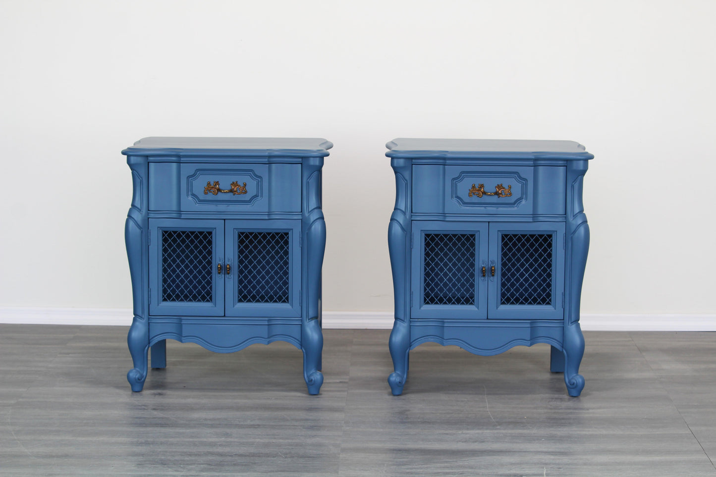 Vintage pair of French style nightstands.  The nightstands are solid built with dovetail joints, and are professionally refinished in blue with a satin finish.  Dimensions; 23" Width x 16"Depth x 28" Height. 