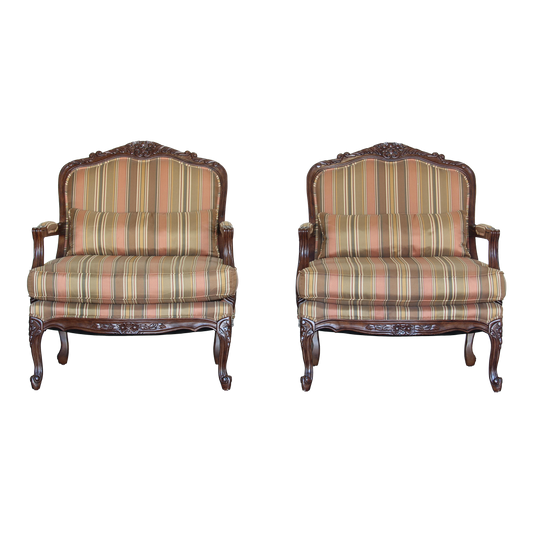 Vintage pair of Louis XV style club chairs.  These chair are solid built with acanthus leaf carving.  These chairs have nicely upholstery in a silk rayon.  Dimensions; 31"Width x 31" Width x 37"Height x 24"Arm Height x 18" Seat Height. 