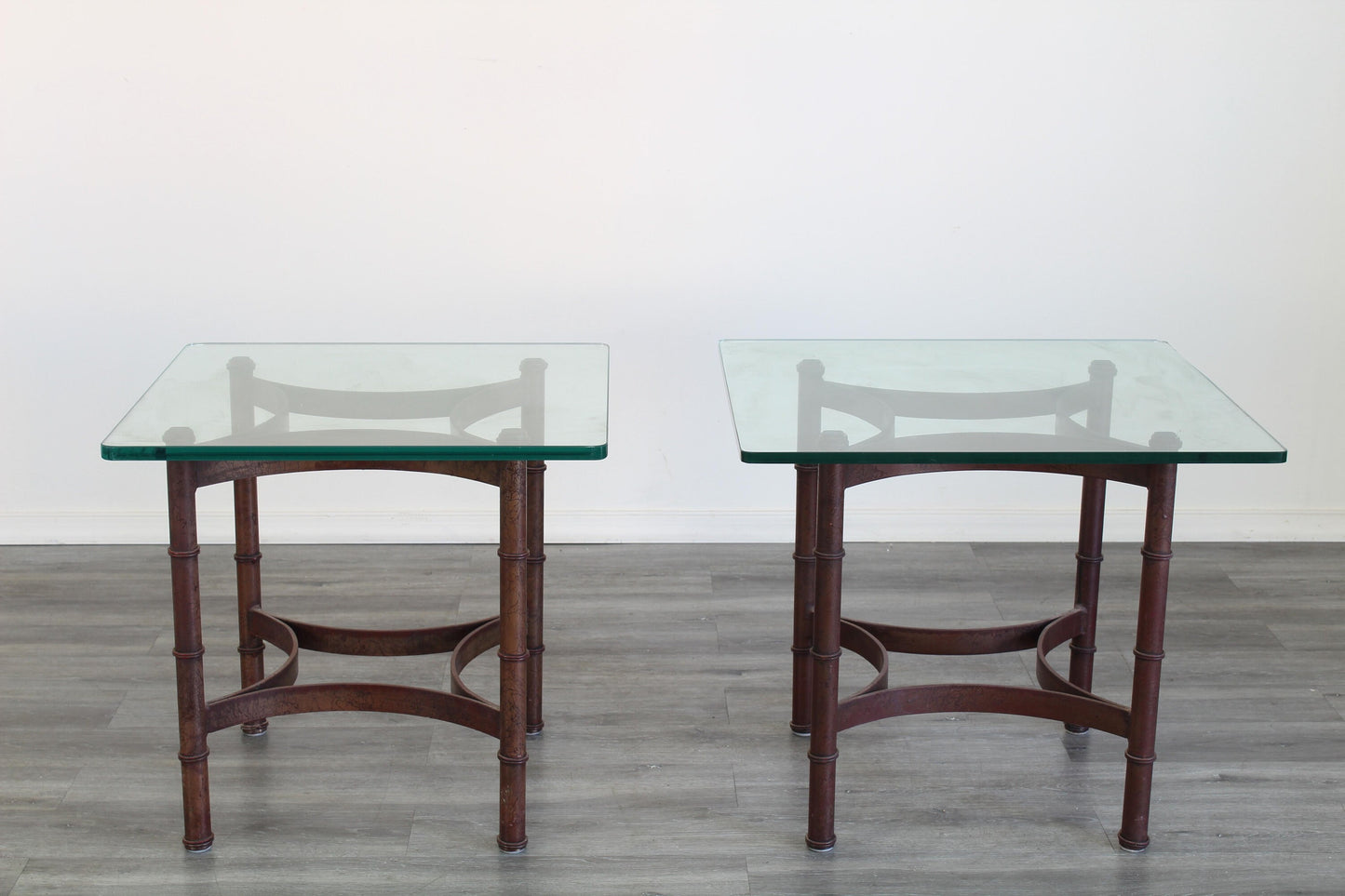 Pair of vintage faux bamboo iron side table with glass top.  This table are gold painted with black splatters.  Dimensions; 24" Width x 24" Depth x 22" Height. 