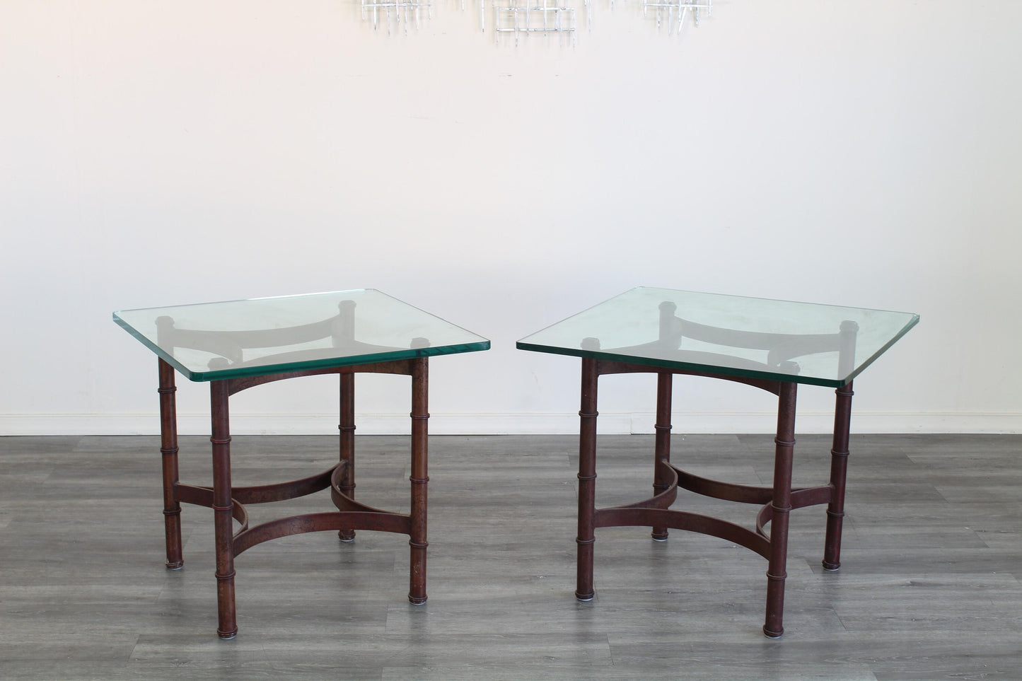 Pair of vintage faux bamboo iron side table with glass top.  This table are gold painted with black splatters.  Dimensions; 24" Width x 24" Depth x 22" Height. 