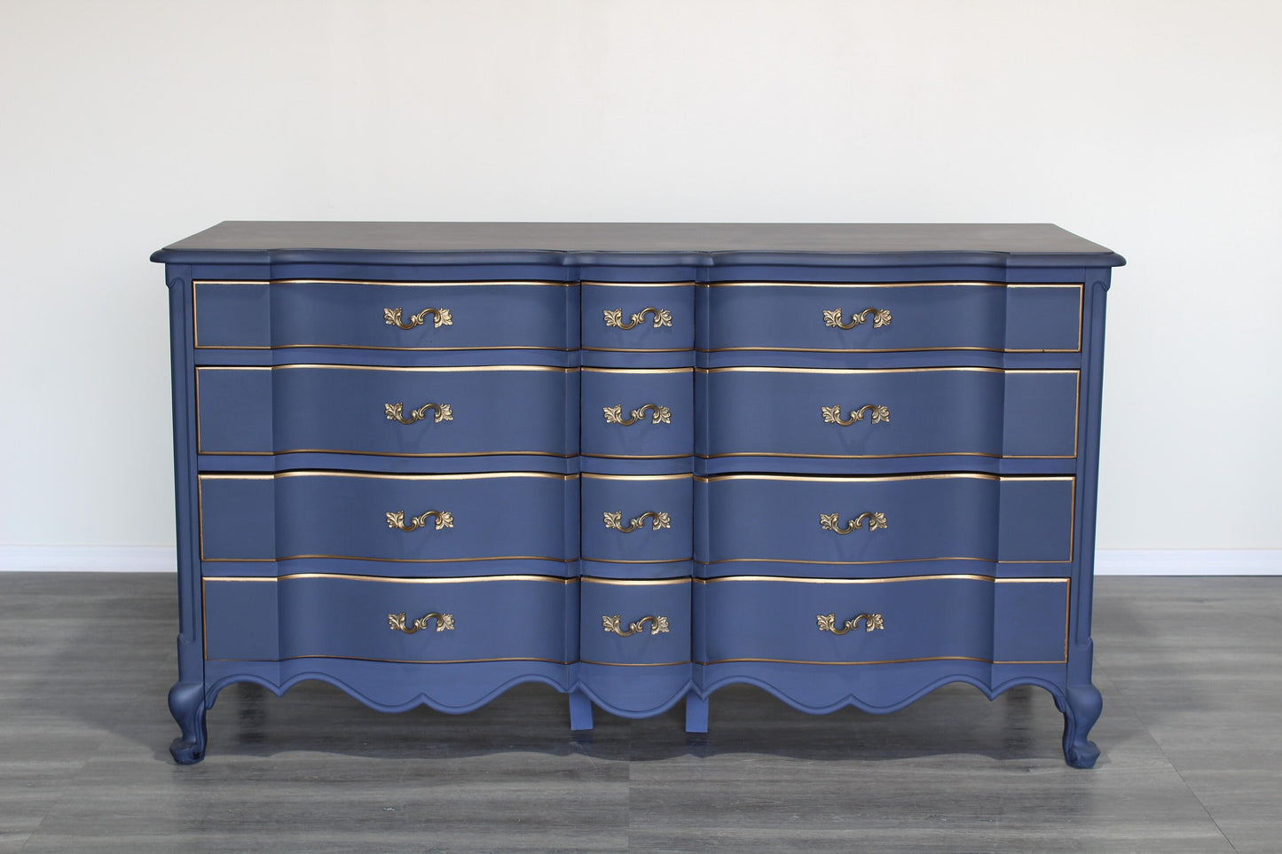 Vintage French provincial blue dresser of twelve drawers.  This dresser is solid built with dovetail joints.  This dresser is painted in blue with antique glaze and gold painted accents.  Dimensions; 62" Width x 22" Depth x 34" Height. 