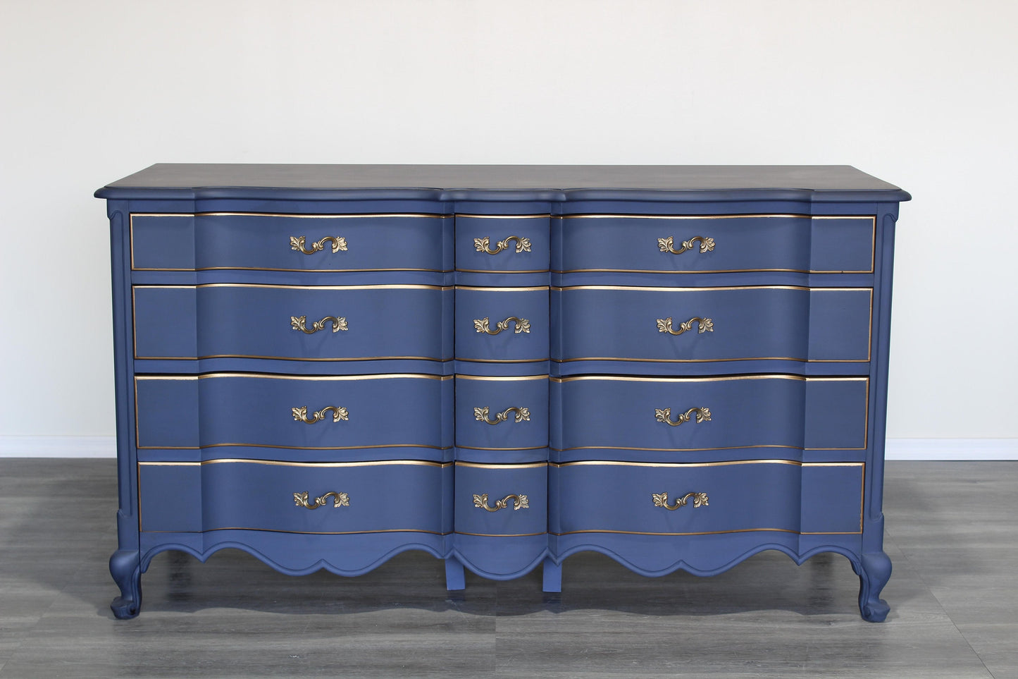 Vintage French provincial blue dresser of twelve drawers.  This dresser is solid built with dovetail joints.  This dresser is painted in blue with antique glaze and gold painted accents.  Dimensions; 62" Width x 22" Depth x 34" Height. 