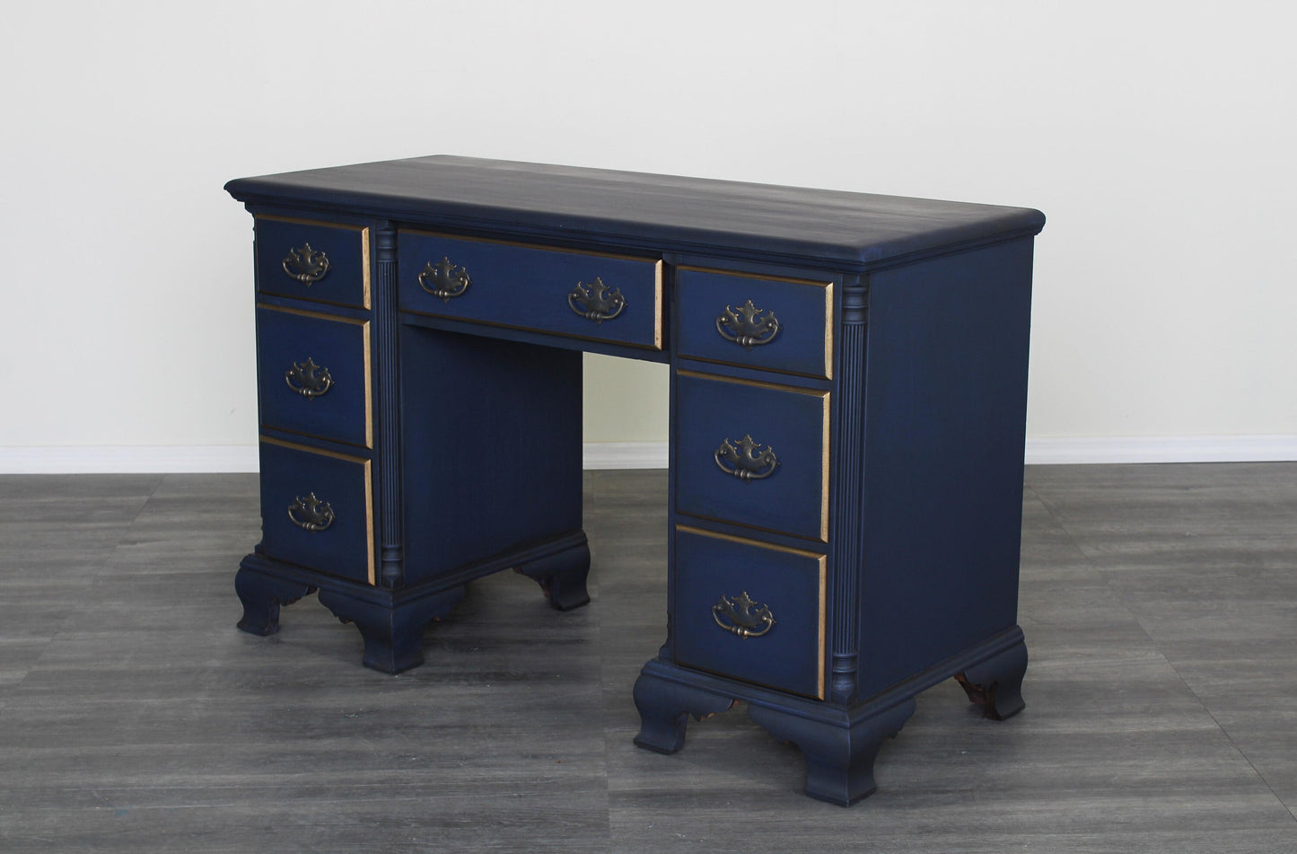 Vintage solid built desk of seven drawers with dovetail joints.  This desk is professionally refinished in blue with antique glaze and dry brushed finish with gold painted accents.   Dimensions; 45" Width x 20" Depth x 31" Height.