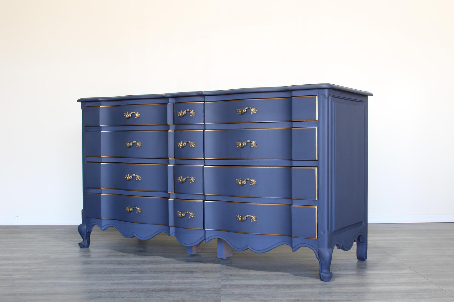 Vintage French provincial blue dresser of twelve drawers.  This dresser is solid built with dovetail joints.  This dresser is painted in blue with antique glaze and gold painted accents.  Dimensions; 62" Width x 22" Depth x 34" Height. 