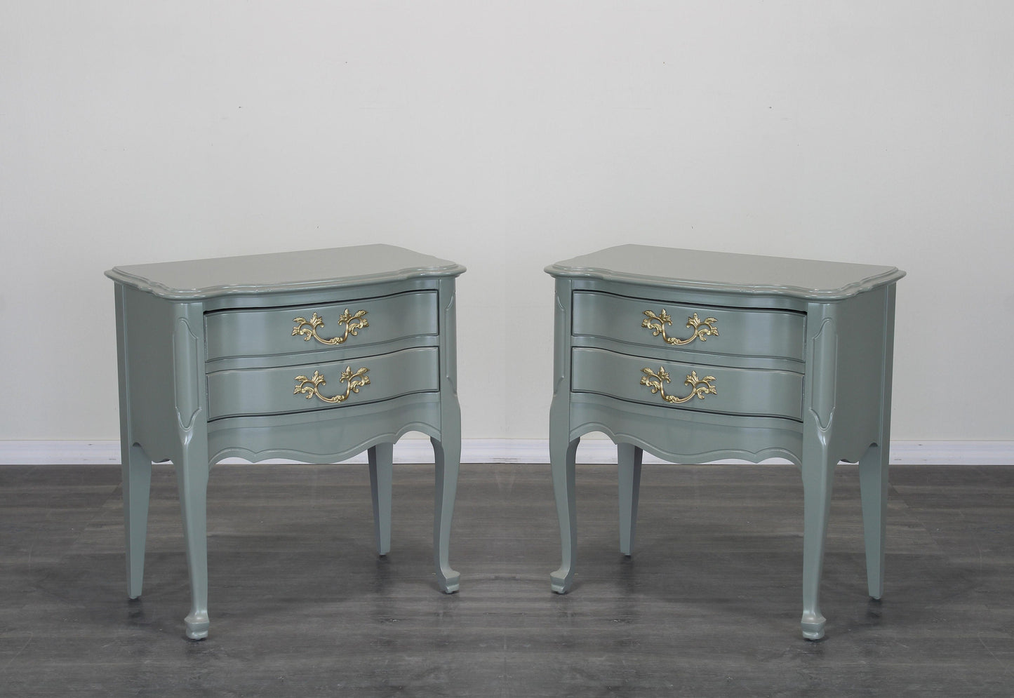 Vintage pair of French style nightstands of two drawers.  These nightstands are professionally refinished in green with satin top coat.  Dimensions: 24"Width x 14"Depth x 25"Height. 